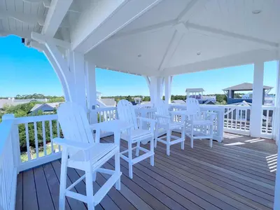 a porch with white chairs and a white canopy at Watersound 13 - Hosted by Top Villas in Watersound Beach