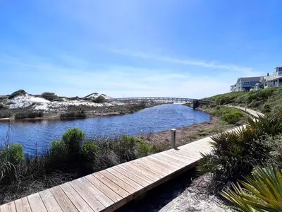 a wooden walkway over a river with a bridge at Watersound 13 - Hosted by Top Villas in Watersound Beach