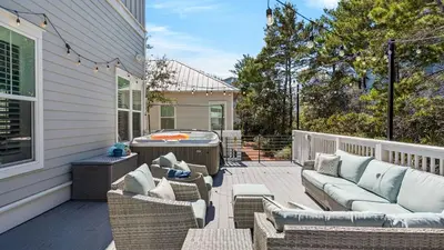 a patio with couches and a hot tub on a house at Coconut Cove by AvantStay Deck w Hot Tub Access to 2 Pools in Santa Rosa Beach