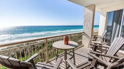 a balcony with chairs and a table and the ocean at South Shore 30A by AvantStay Gulf View Pool Bonfires in Rosemary Beach