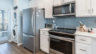 a kitchen with a stainless steel refrigerator and a microwave at South Shore 30A by AvantStay Gulf View Pool Bonfires in Rosemary Beach