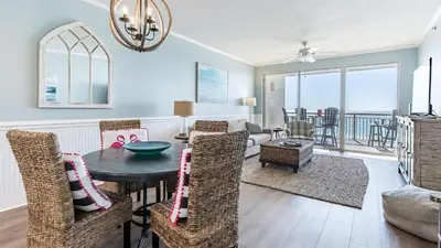 a living room with a table and chairs at South Shore 30A by AvantStay Gulf View Pool Bonfires in Rosemary Beach