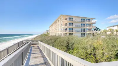 a boardwalk leading to the beach and a building at South Shore 30A by AvantStay Gulf View Pool Bonfires in Rosemary Beach