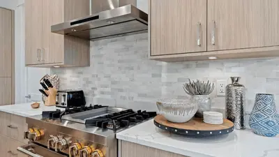 a kitchen with a stove and a counter top at Out of Office Beaches Private Pool Steps to Beach Sleeps 15 in Rosemary Beach