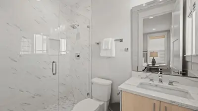a bathroom with a toilet and a sink and a shower at Out of Office Beaches Private Pool Steps to Beach Sleeps 15 in Rosemary Beach