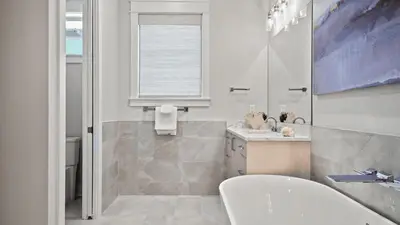 a bathroom with a white tub and a sink at Out of Office Beaches Private Pool Steps to Beach Sleeps 15 in Rosemary Beach
