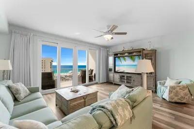 a living room with a couch and a flat screen tv at Modern Resort Condo! Gulf Views & Amenities Galore! presented by Dolce Vita Getaways! in Panama City Beach