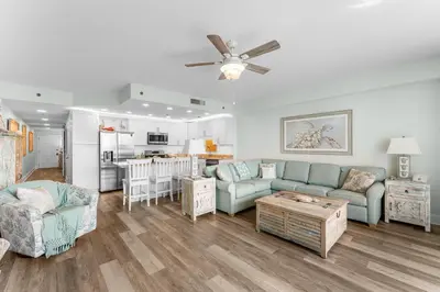 a living room with a couch and a table at Modern Resort Condo! Gulf Views & Amenities Galore! presented by Dolce Vita Getaways! in Panama City Beach