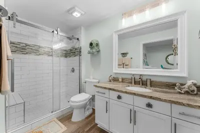 a bathroom with a toilet and a sink and a shower at Modern Resort Condo! Gulf Views & Amenities Galore! presented by Dolce Vita Getaways! in Panama City Beach