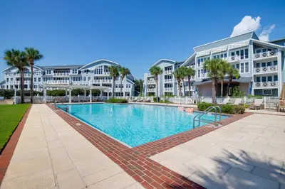 a swimming pool in front of a large apartment building at Gulf Front- Large Pool- Watersound on 30A in Santa Rosa Beach