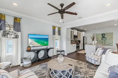 a living room with a couch and a tv at 6-Seater Golf Cart - Community Pool - Close to Beach, Dining and Shopping in Inlet Beach