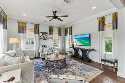 a living room with a couch and a tv at 6-Seater Golf Cart - Community Pool - Close to Beach, Dining and Shopping in Inlet Beach