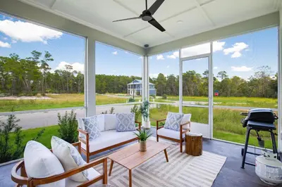 a screened in porch with chairs and a table at Community Pool, Close to Beach, Great Location! in Inlet Beach