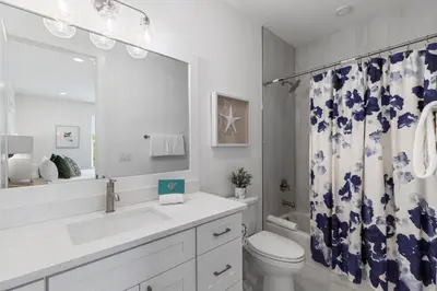 a bathroom with a sink and a toilet and a shower curtain at Community Pool, Close to Beach, Great Location! in Inlet Beach