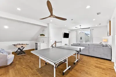 a living room with a ping pong table and a couch at Golf Cart-Private Pool and Hot Tub-Close to Beach in Santa Rosa Beach