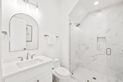 a white bathroom with a sink and a shower at Golf Cart-Private Pool and Hot Tub-Close to Beach in Santa Rosa Beach
