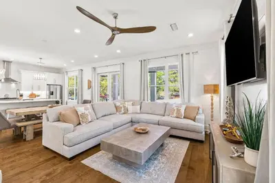 a living room with a couch and a table at Golf Cart-Private Pool and Hot Tub-Close to Beach in Santa Rosa Beach