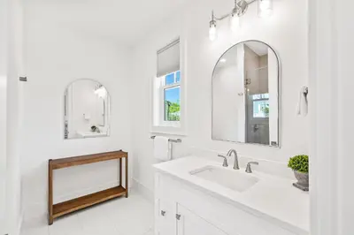 a white bathroom with a sink and a mirror at Golf Cart-Private Pool and Hot Tub-Close to Beach in Santa Rosa Beach