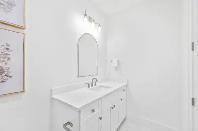 a white bathroom with a sink and a mirror at Golf Cart-Private Pool and Hot Tub-Close to Beach in Santa Rosa Beach