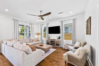 a living room with two couches and a flat screen tv at Golf Cart-Private Pool and Hot Tub-Close to Beach in Santa Rosa Beach