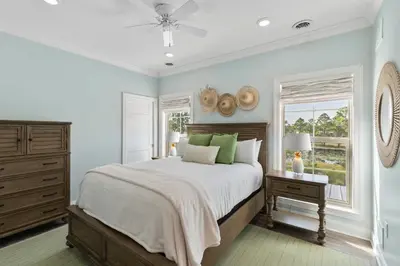 a bedroom with a large bed and a window at Pool, 30A, Fire Table, Gourmet Kitchen, Luxury in Santa Rosa Beach