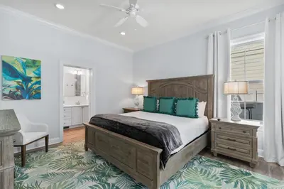 a bedroom with a bed and a chair and a window at Pool, 30A, Fire Table, Gourmet Kitchen, Luxury in Santa Rosa Beach