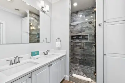 a bathroom with two sinks and a shower at Pool, 30A, Fire Table, Gourmet Kitchen, Luxury in Santa Rosa Beach