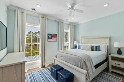 a bedroom with a bed and a window at Pool, 30A, Fire Table, Gourmet Kitchen, Luxury in Santa Rosa Beach