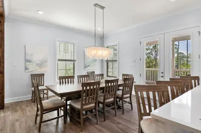 a dining room with white walls and a table and chairs at Pool, 30A, Fire Table, Gourmet Kitchen, Luxury in Santa Rosa Beach