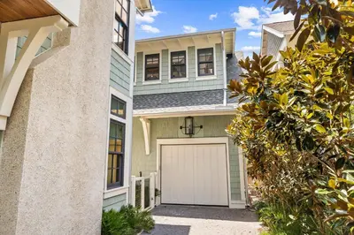 a house with a garage in front of it at Tranquility on the Preserve in Watersound Beach