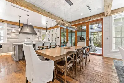 a kitchen and dining room with a wooden table and chairs at Tranquility on the Preserve in Watersound Beach