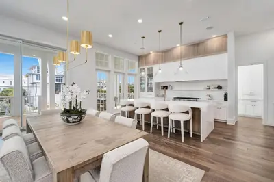 a kitchen and dining room with a table and chairs at No More Cloudy Days in Santa Rosa Beach