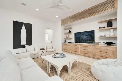 a living room with a white couch and a table at No More Cloudy Days in Santa Rosa Beach