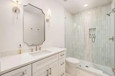 a white bathroom with a sink and a shower at No More Cloudy Days in Santa Rosa Beach