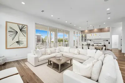 a living room with a white couch and a table at No More Cloudy Days in Santa Rosa Beach