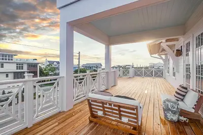 a white porch with a view of the ocean at No More Cloudy Days in Santa Rosa Beach