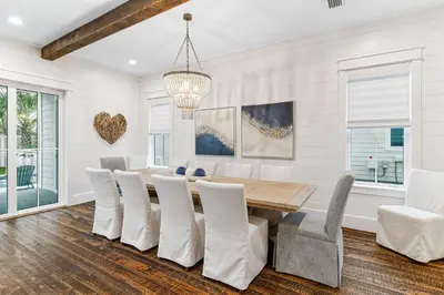 a dining room with a table and chairs at Breezy Blue in Santa Rosa Beach