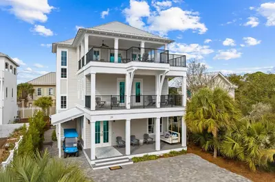an aerial view of a white house with a balcony at Breezy Blue in Santa Rosa Beach