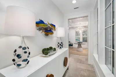 a white living room with a vase on a shelf at Sunset at 409 in Watersound Beach