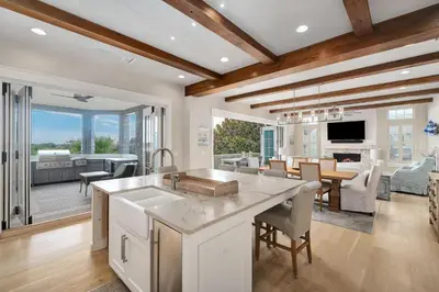 a kitchen and living room with a table and a dining room at Sunset at 409 in Watersound Beach