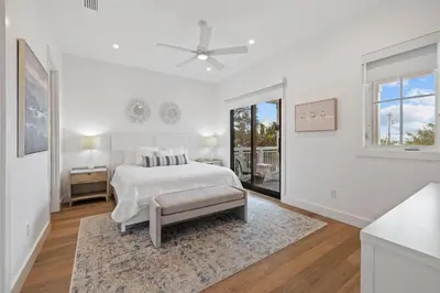 a white bedroom with a bed and a window at Eyes on Sunrise in Seacrest