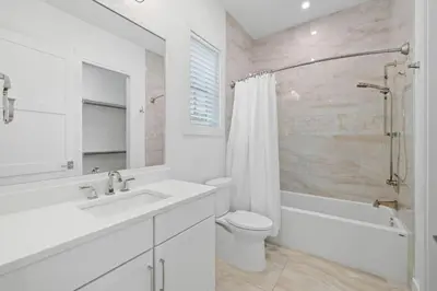 a white bathroom with a sink and a toilet at Eyes on Sunrise in Seacrest