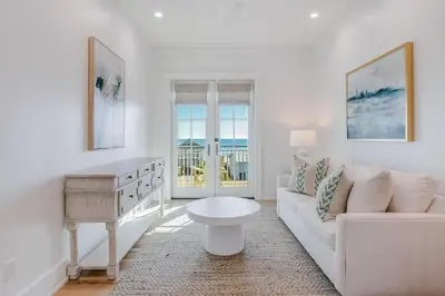 a living room with a white couch and a table at Coastal Comfort in Seacrest