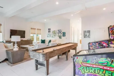 a living room with a ping pong table at Coastal Comfort in Seacrest