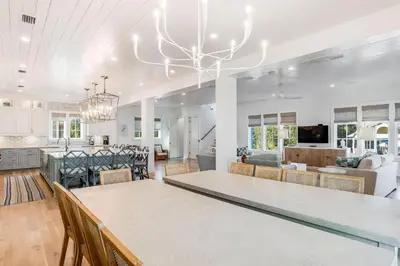 a large kitchen and living room with a large dining table at Coastal Comfort in Seacrest