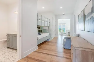 a white room with a bed and a desk at Coastal Comfort in Seacrest
