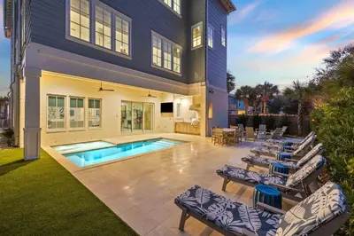 a house with a swimming pool and lounge chairs at Coastal Comfort in Seacrest