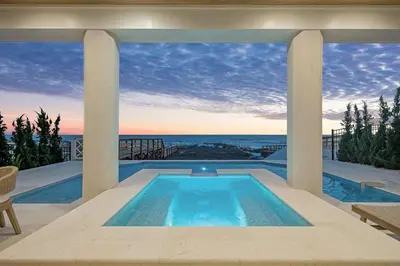 a house with a swimming pool with a view of the ocean at Selah at the Sea in Santa Rosa Beach