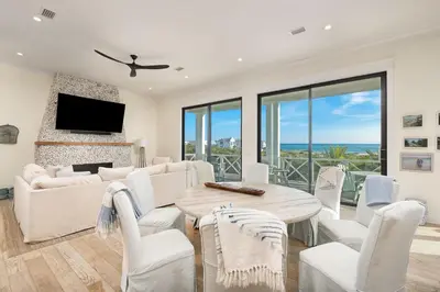 a living room with a couch and a table and chairs at Belle La Mer in Inlet Beach