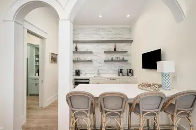 a kitchen with a white table and chairs at Belle La Mer in Inlet Beach